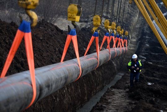 Pipeline being lowered into trench